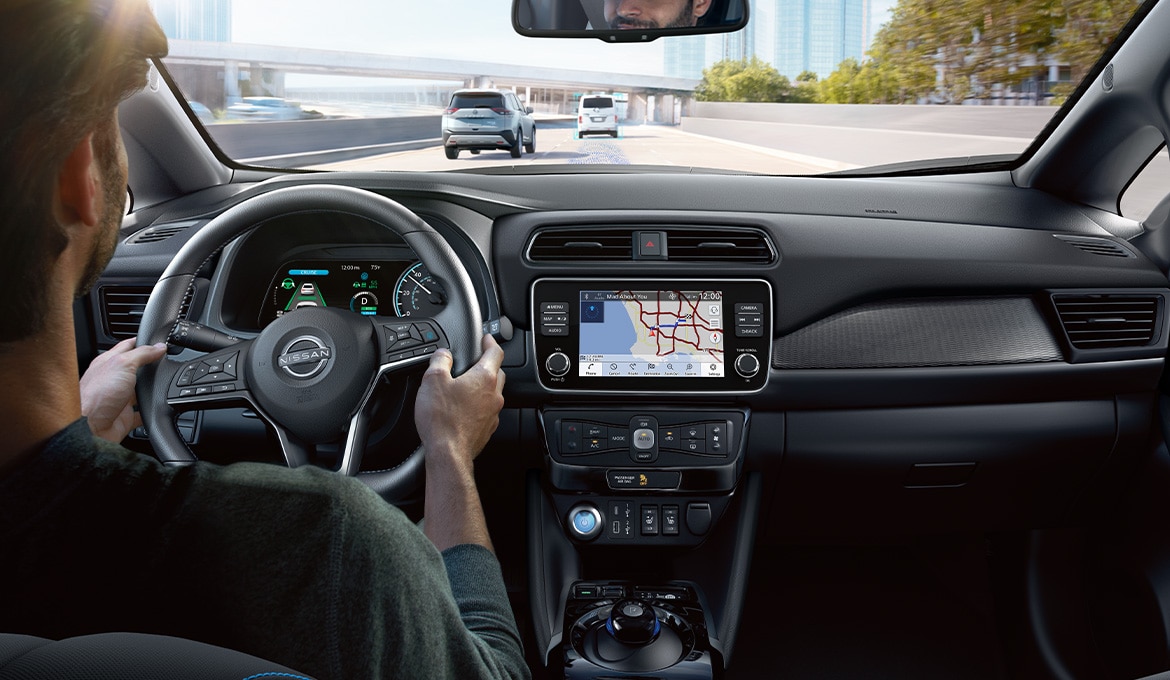 2024 Nissan LEAF cockpit while person driving illustrating driver assist systems
