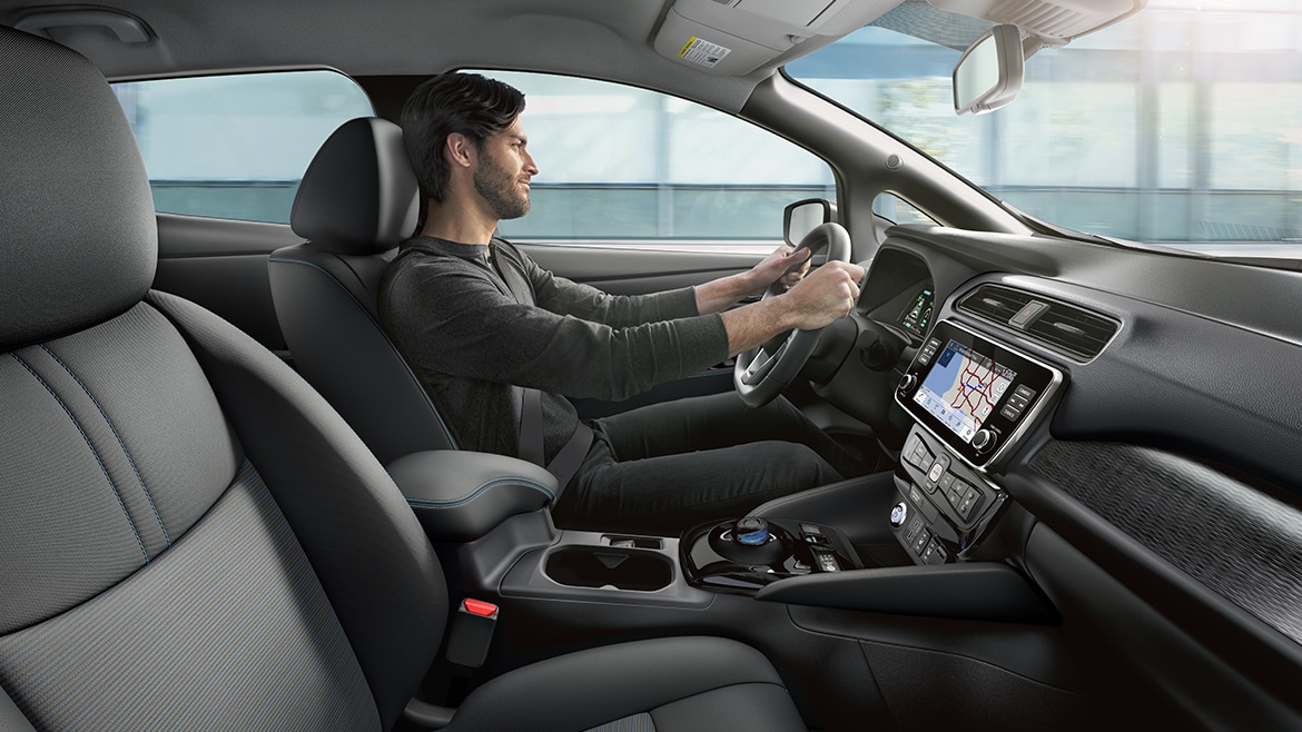 2024 Nissan LEAF interior with person driving to illustrate interior