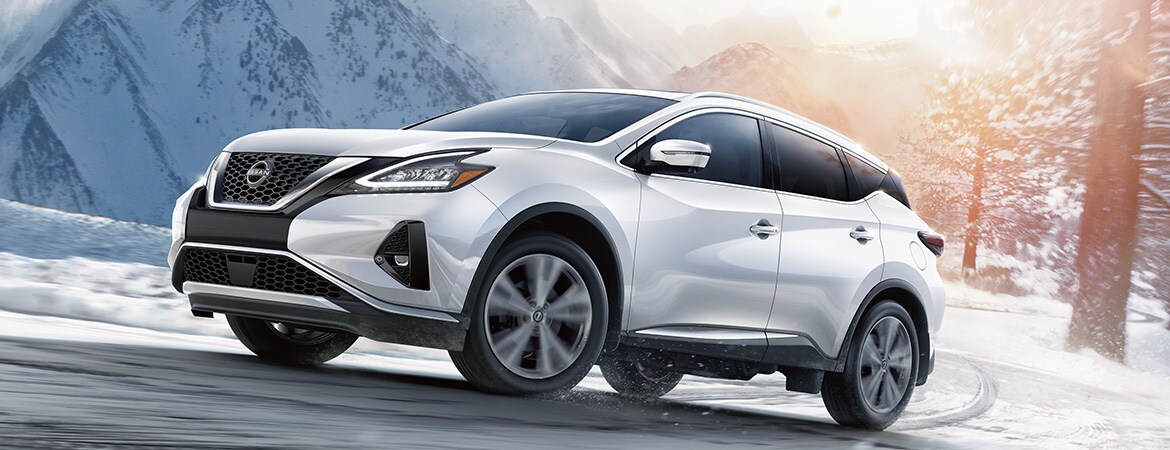 2023 Nissan Murano all-wheel-drive driving up a hill on a snowy road.