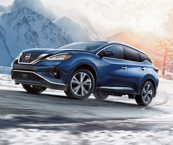 2024 Nissan Murano with bold, aggressive styling driving up a snowy mountain road