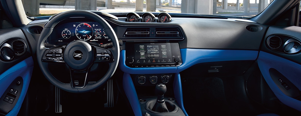 2023 Nissan Z blue interior cockpit showing performance digital dashboard and iconic triple gauge cluster.