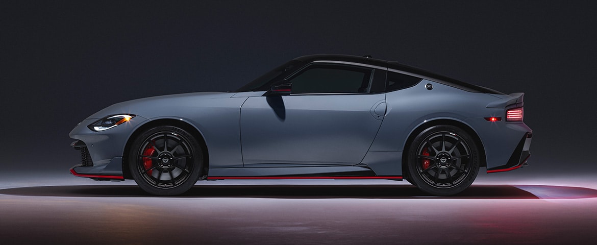 2024 Nissan Z NISMO side profile with lights on, in a clean, darkened room
