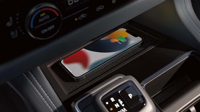 2024 Nissan Pathfinder detail view of interior showing iPhone displaying Apple CarPlay® logo.