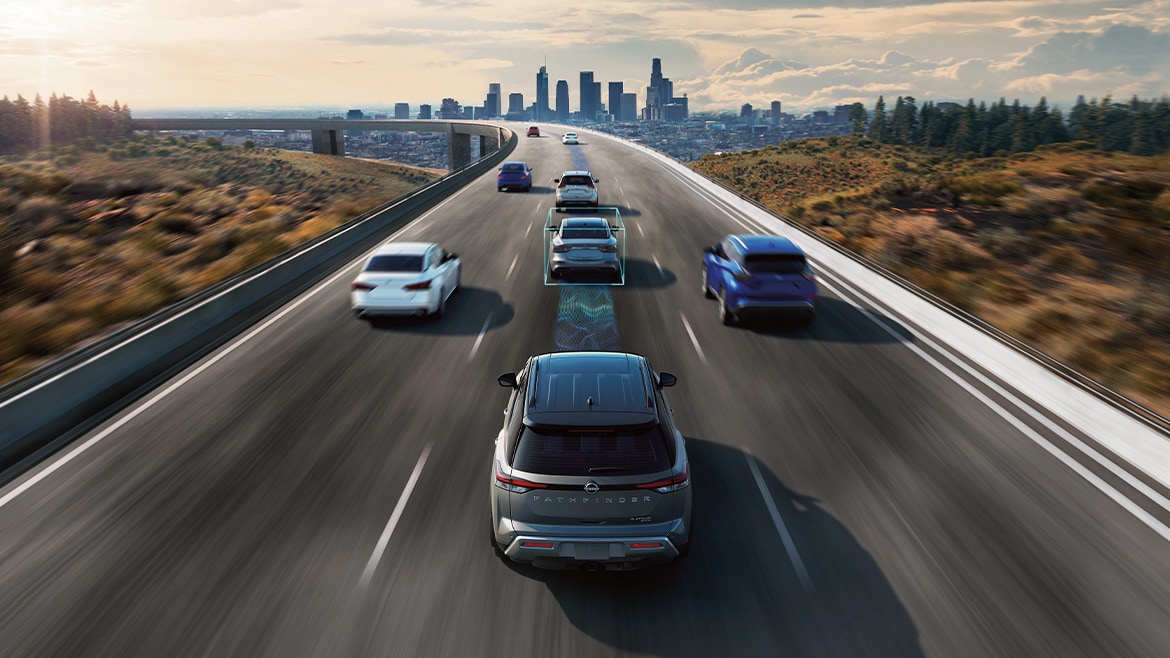 2024 Nissan Pathfinder on highway illustrating propilot assist technology sensors monitoring traffic ahead.