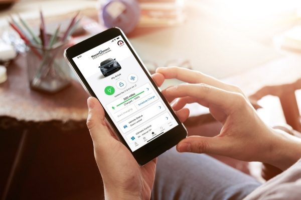 Nissan ARIYA smartphone with NissanConnect® app displayed