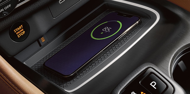 2024 Nissan Rogue, interior detail with smartphone on wireless charging pad