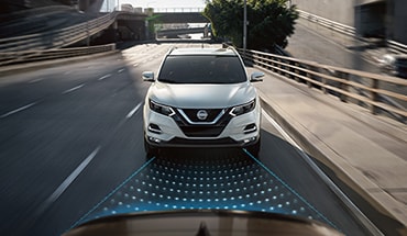 2021 Nissan Rogue Sport on the road showing automatic emergency braking with pedestrian detection technology