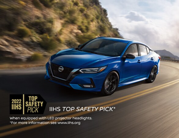 2022 Nissan Sentra in Electric Blue Metallic driving swiftly in the mountains. 