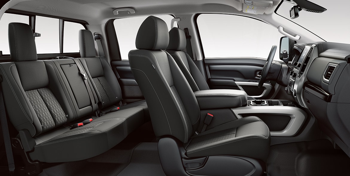 2021 Nissan TITAN XD front and back seats in stain-resistant cloth seen from passenger side 