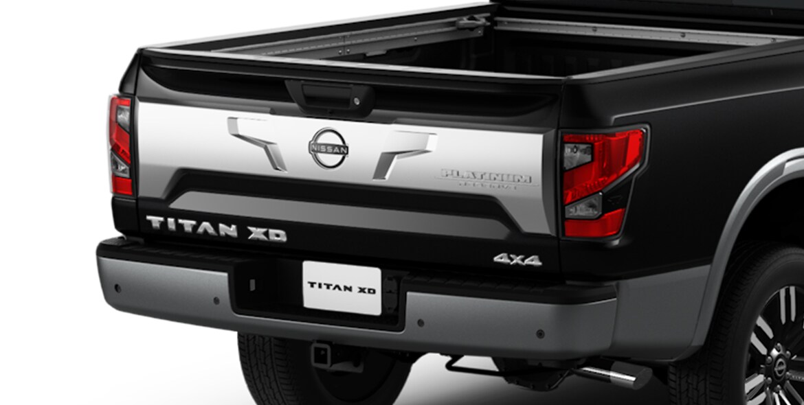 2023 Nissan TITAN XD showing brushed satin-finished tailgate with platinum reserve badging.