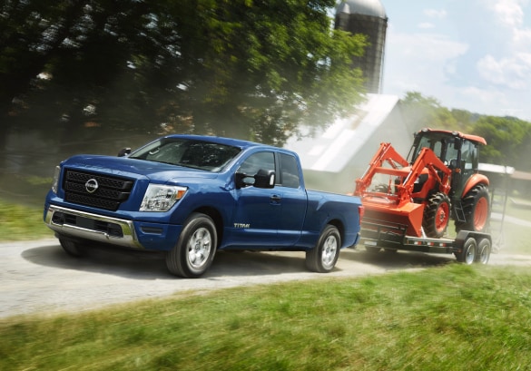 Nissan TITAN Pickup Truck Towing a Tractor