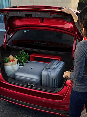 2023 Nissan Versa showing large trunk with groceries and luggage inside.