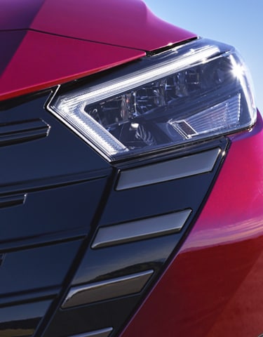 2024 Nissan Versa front detail showing signature LED daytime running lights