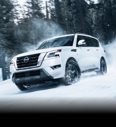 2023 Nissan Armada off roading through snowy forest terrain